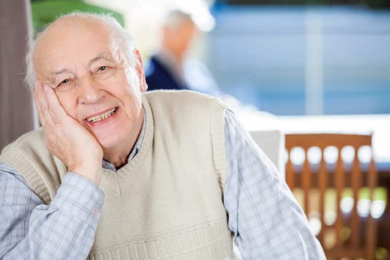 Smiling senior man sitting down