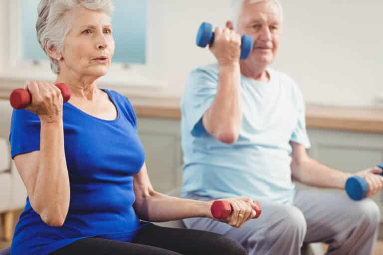Senior couple exercising with hand weights