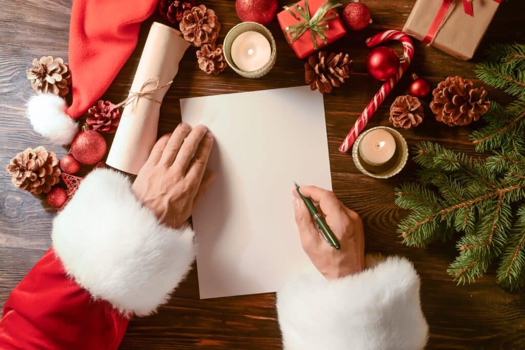 Santa hands writing letter